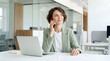 © OKKI RIZKI - Young Businesswoman Smiling While Talking on Red Smartphone in Modern Office