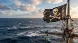 Weathered pirate flag with skull and crossbones flying from an old sailing ship mast above the open sea. Adventure, piracy and maritime history concept