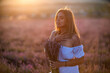 © svetograph - Woman lavender bouquet golden hour portrait expressing peaceful emotion in sunlit field