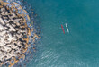 © AmazingAerialAgency - Aerial view of two kayaks paddling near the concrete breakwater of Herzliya Beach in Herzliya, Tel Aviv District, Israel.