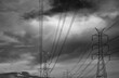 © Fahroni - High voltage electricity transmission towers beneath dramatic storm clouds. Power grid infrastructure, energy security, electrical transmission network and climate resilience during severe weather.