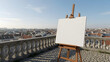 ©  Recurrent Creatives - Empty Artist Canvas on Wooden Easel Outdoors with City View.