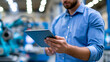© Nataliya - Faceless industrial worker monitoring automation machines through a digital tablet in a smart manufacturing facility, smart manufacturing, industrial automation, digital tablet