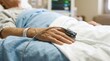 © Shelly - Elderly Patient in Hospital Bed with Pulse Oximeter on Finger and Vital Signs Monitor