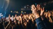 © tanin - Audience applauds performer under stage lights, celebrating a successful show with hands clapping in unison.