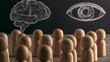 © Prasanth - Wooden figures regard the chalkboard, where thought and perception are symbolized by their eyes and brain.