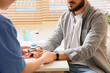 © Pixel-Shot - Medical professional checking patients oxygen saturation with a pulse oximeter during a health examination