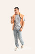 © Pixel-Shot - Handsome young happy man in stylish outfit with mobile phone on grey background