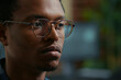 © DC Studio - Focused portrait with software developer with glasses reading AI algorithm working focused looking at computer screen around computer screens, showing developer teamwork, source code discussion.