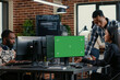 © DC Studio - Developers analyze source code with green screen while colleagues work on algorithms and a chroma key mockup supports replaceable software screen use.