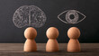 © Selvam - Wooden figures gaze at the chalkboard, symbolizing thought and perception.
