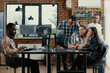 © DC Studio - Junior developers asking senior programmer for algorithm help in a software office, showing source code, programming workflow and technical collaboration on digital development tasks.