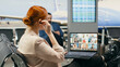 © DC Studio - Woman joins a video call briefing on a laptop in an airport lounge, discussing corporate updates with workers and shareholders during international business travel and virtual communication on the go.