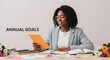 © Bong - Focused Black Female Startup Founder Reviewing Documents at Her Desk, Planning for Business Success