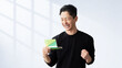 © Trickster* - 通帳を見て喜ぶ男性, Happy Man Looking at a Bankbook