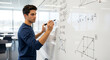 © Shawn - Smart male student solving complex algebra formulas on whiteboard in classroom