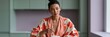 © Iryna - Woman stirring soup in kitchen wearing floral robe for lifestyle banner and culinary background