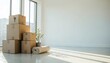 © Cherrita07 - Stacked cardboard boxes near a large window in an empty room with sunlight