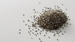 © GROW HIGH - Small pile of raw organic black and white chia seeds resting on a smooth grey surface