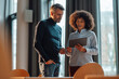 © Westend61 - Business colleagues discussing over tablet PC at work place