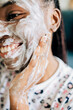 © Olly R/Stocksy - Closeup portrait of african american woman washing face with foam