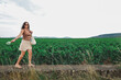 © Mat Hayward - Woman walking beside vineyards in Puligny-Montrachet, Burgundy, France, surrounded by expansive wine country landscapes and historic viticultural heritage.