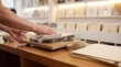 © Stitch - Person gently cleaning the dust cover of a modern wooden turntable with a microfiber cloth