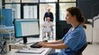 © JohnLee - Modern private clinic featuring nurse using computer, wheelchair patient exiting elevator, and doctors collaborating nearby.