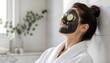 © ArtSync Studio - Relaxed Woman Wearing Black Charcoal Facial Mask with Cucumber Slices for Skin Rejuvenation