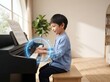 © surya - Boy Playing Piano With Glowing Notes