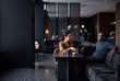 © AdPremium - Diverse man and woman having a conversation in a modern luxury hotel lobby lounge during a business meeting