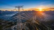 © Zhang - Power transmission towers across mountainous landscape at sunset