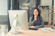 © MrAshi - Asian businesswoman showing financial chart on clipboard during online video conference call on tablet.