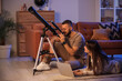 © Pixel-Shot - Young couple with laptop looking through telescope in room at night