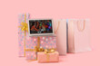 © Pixel-Shot - People celebrating Birthday online on screen of laptop and gifts against pink background