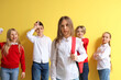 © Pixel-Shot - Bullied little girl and her classmates on yellow background