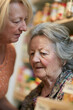 © ON - Studio - Elderly woman with memory loss labeling kitchen drawers with daughter's help