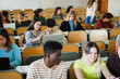 © DisobeyArt - Students inside university class room using laptop - Back to school and campus lifestyle concept - Main focus on center girl face - UGC content