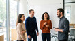 © Olena Apetroaiei - Coworkers laugh together around a blank whiteboard in a sunlit meeting room, capturing bright, collaborative team connection.