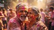 © BayuP - Vibrant Holi celebration of an elderly Indian couple sharing a joyful moment, covered in colorful powders