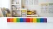 © Kaff - Colorful wooden toy blocks lined up in blurred classroom