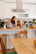 © Impact Photography - Mother and daughter making coffee and hot cocoa in the kitchen