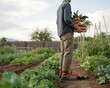 © snapnest07 - Person holding fresh vegetables from a wellmaintained organic garden