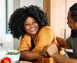 © Lumos sp - Portrait of a happy young black couple dating and flirting in a restaurant, or at home in kitchen, love and relationship concept