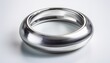 © Sondra - metallic silver ring hovering over a white background creating a sleek and modern aesthetic ideal for various design projects