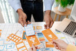 © Imagestoyou - A UX design team collaborates with wireframes, interface cards, color palettes, and mobile app prototypes to improve user experience, design systems, product strategy, and digital innovation.