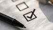 © Irfan - A pen rests beside a checklist with a checked box and an empty one