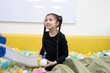 © chachamp - Girl playing with spring toy in ball pit
