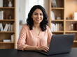 © Someone Cooked Here - professional woman working on a laptop in a modern home office representing remote work productivity online business consulting education and digital entrepreneurship