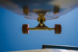 Close up view of skateboard trucks and wheels above a skate ramp